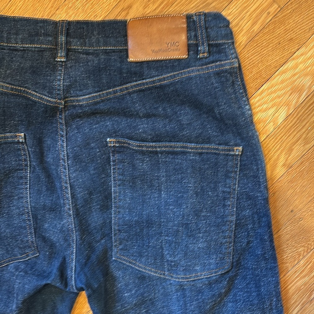 YMC Stretchy jeans with novelty dropped back pocket placement
